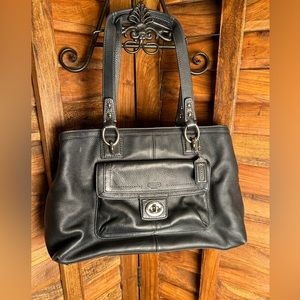 Coach. Butter-soft, black pebbled leather bag. Great hardware and clasp. Classy.